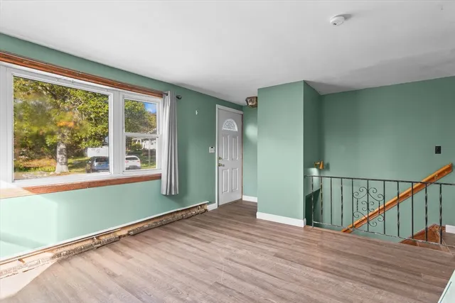 a view of a room with wooden floor and windows