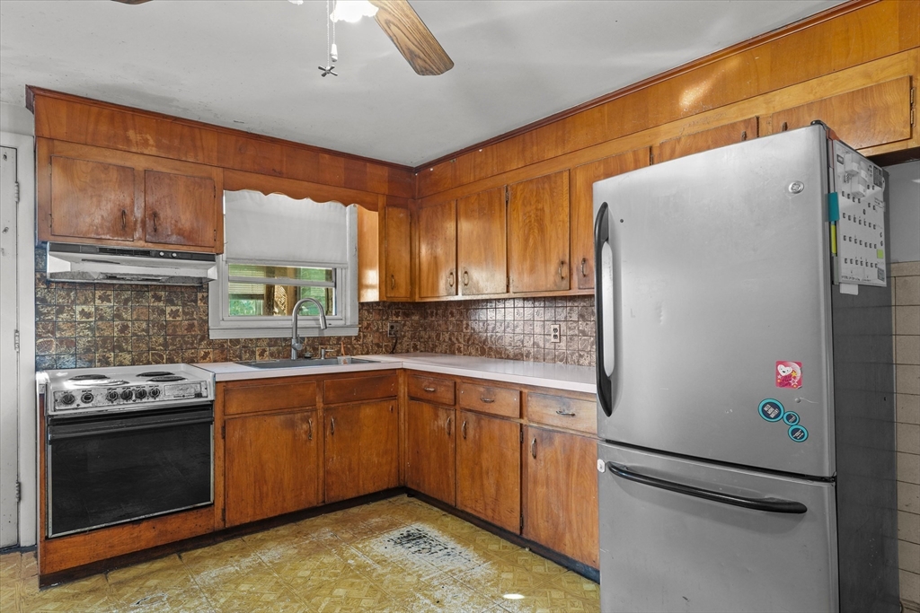 46 Staaf Road Saugus, MA 01906 - Photo 5 of 19 a kitchen with stainless steel appliances granite countertop a sink stove and refrigerator