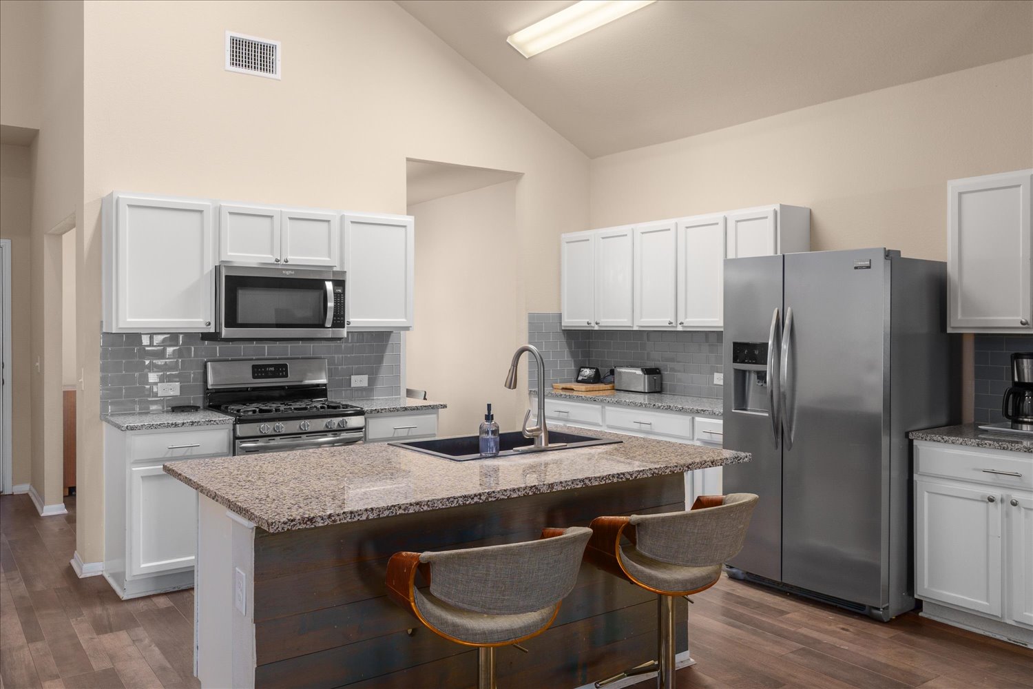 717 Kaluga Trail Leander, TX 78641 - Photo 11 of 40 a kitchen with granite countertop a sink stove and refrigerator