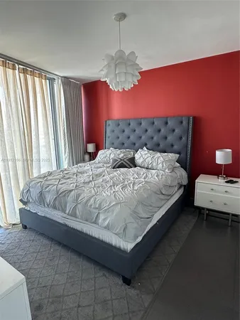 a bedroom with a bed window and couch