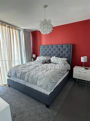 a bedroom with a bed window and couch