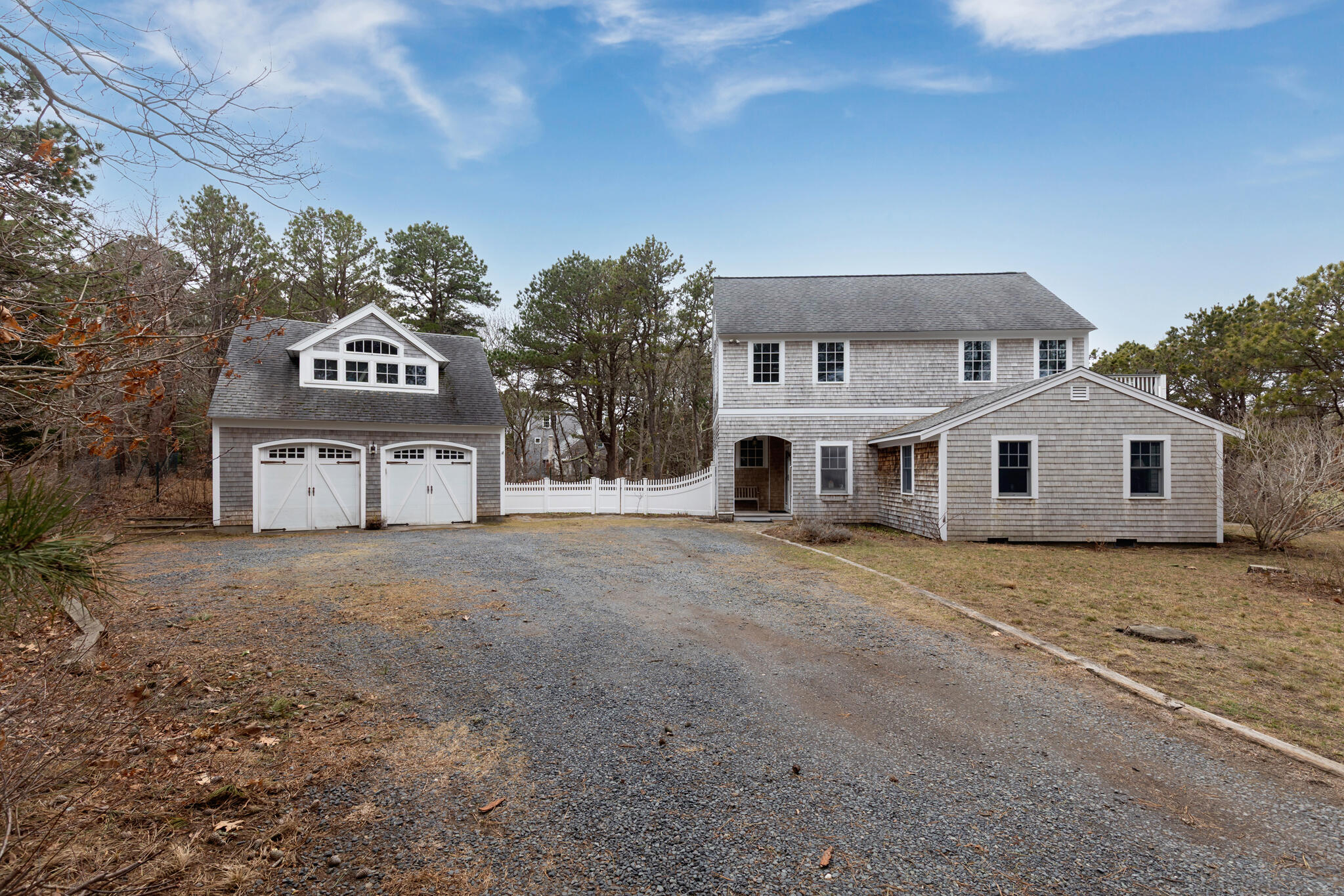 311 South Sunken Meadow Road Eastham, MA 02642 - Photo 6 of 57 a front view of a house with a yard and garage