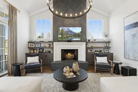 a living room with furniture a fireplace and a large window