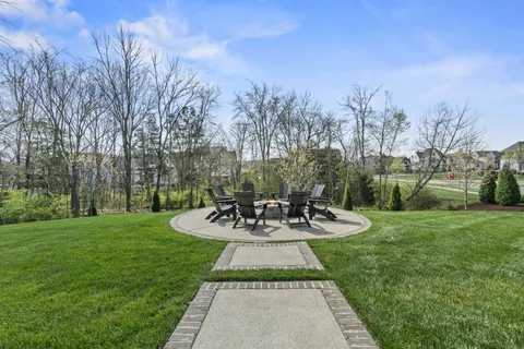 a view of a house with backyard sitting area and garden