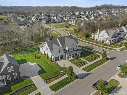 a aerial view of a house next to a yard
