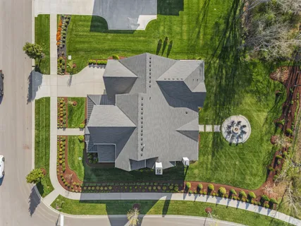 an aerial view of a house with garden space and street view