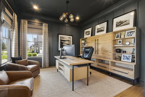a living room with furniture a chandelier and a flat screen tv