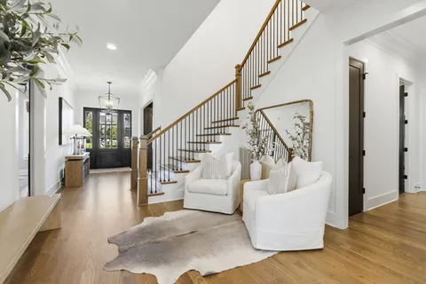 a view of entryway and hall with wooden floor