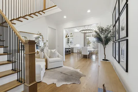 a living room with furniture and a fireplace with wooden floor