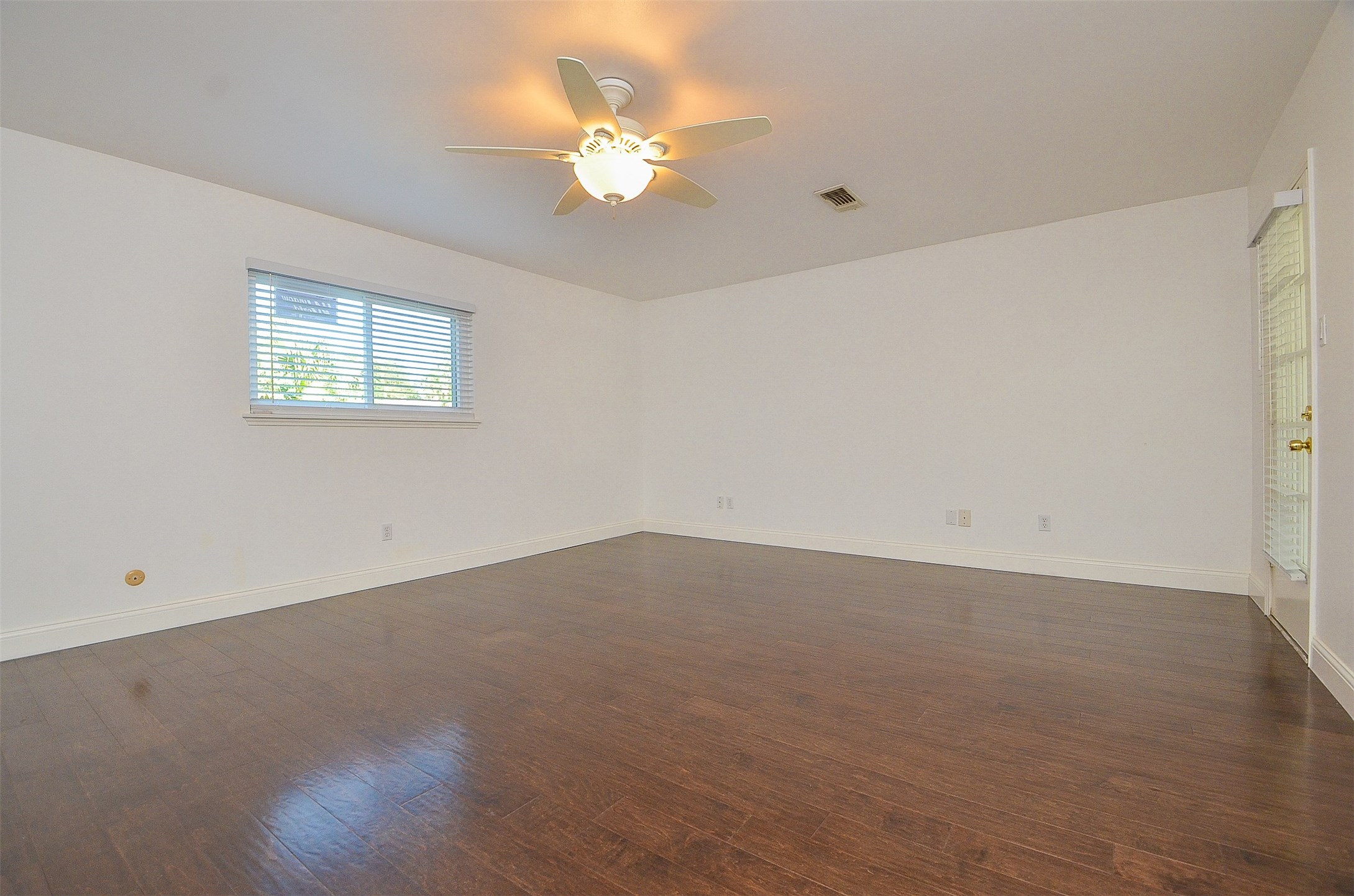 710 South Fry Road Katy, TX 77450 - Photo 43 of 50 Entrance view of masterroom with brand new hardwood flooring and window/blind and door aceess to the exterior corridor.