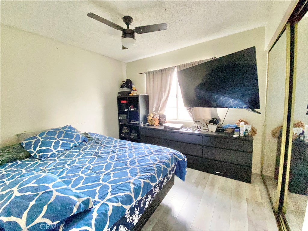 1444 North Sage Avenue Rialto, CA 92376 - Photo 12 of 22 a bedroom with a bed and a flat screen tv