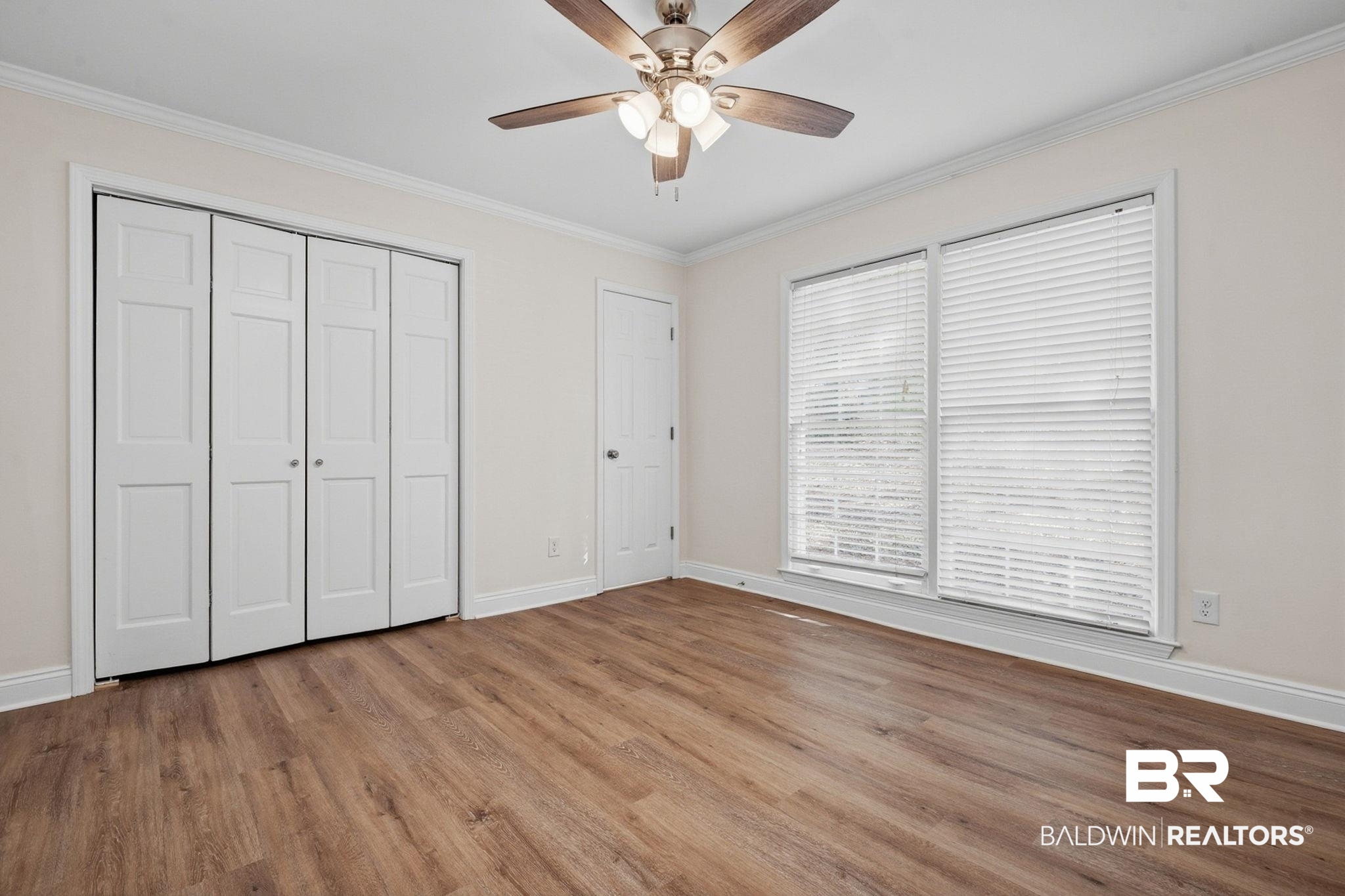 814 Nassau Drive Mobile, AL 36608 - Photo 27 of 44 Unfurnished bedroom with a closet, a ceiling fan, ornamental molding, and wood finished floors
