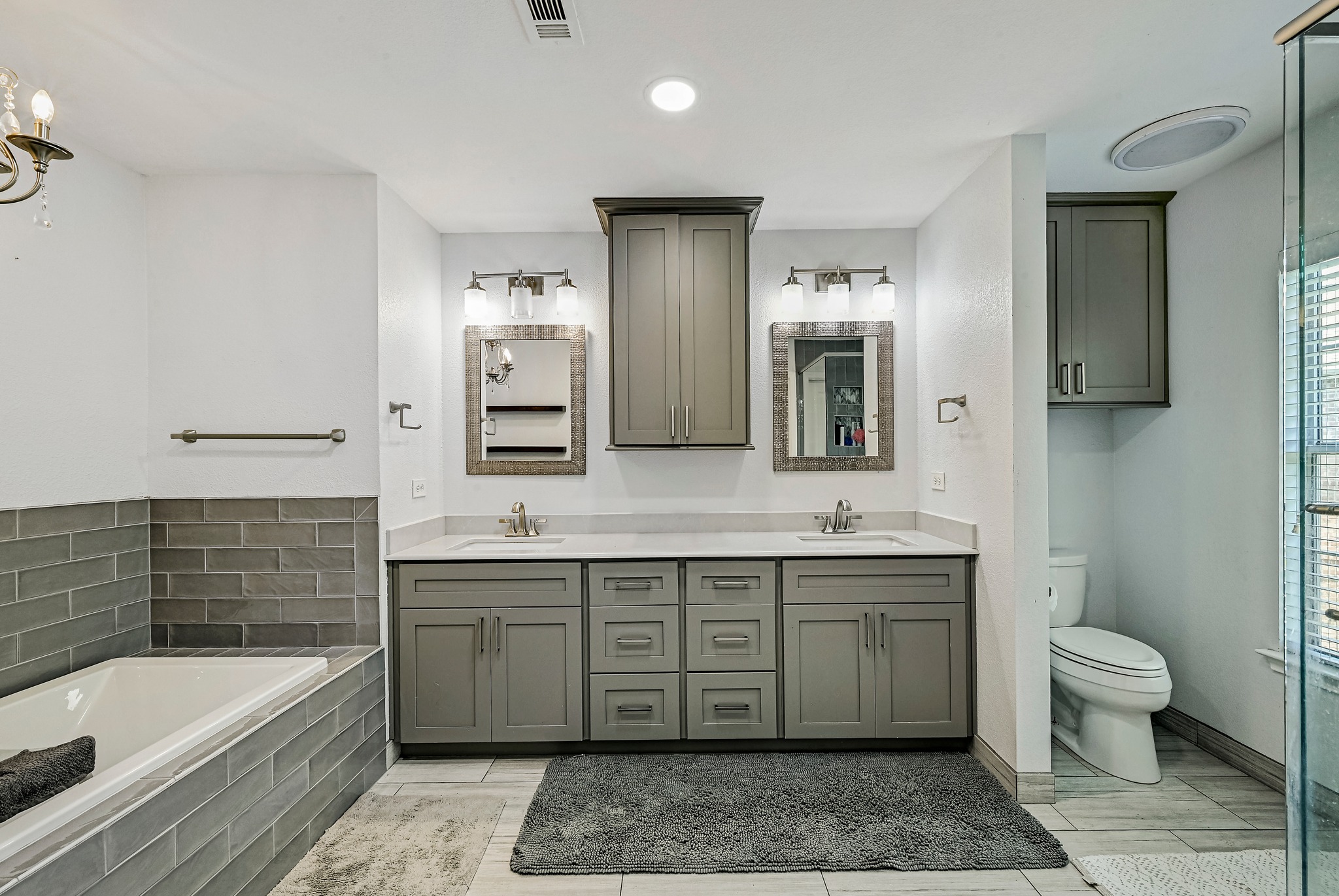 104 North Sumac Lane Georgetown, TX 78633 - Photo 30 of 40 Dual vanities and a deep soaking tub create a luxurious and functional primary bathroom retreat.