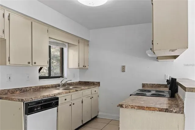 a kitchen with stainless steel appliances granite countertop a sink and a stove