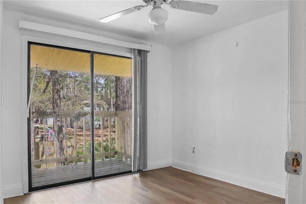 713 Southwest 69th Street Gainesville, FL 32607 - Photo 13 of 22 wooden floor in an empty room with a window