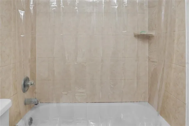 a bathroom with a sink vanity mirror and toilet