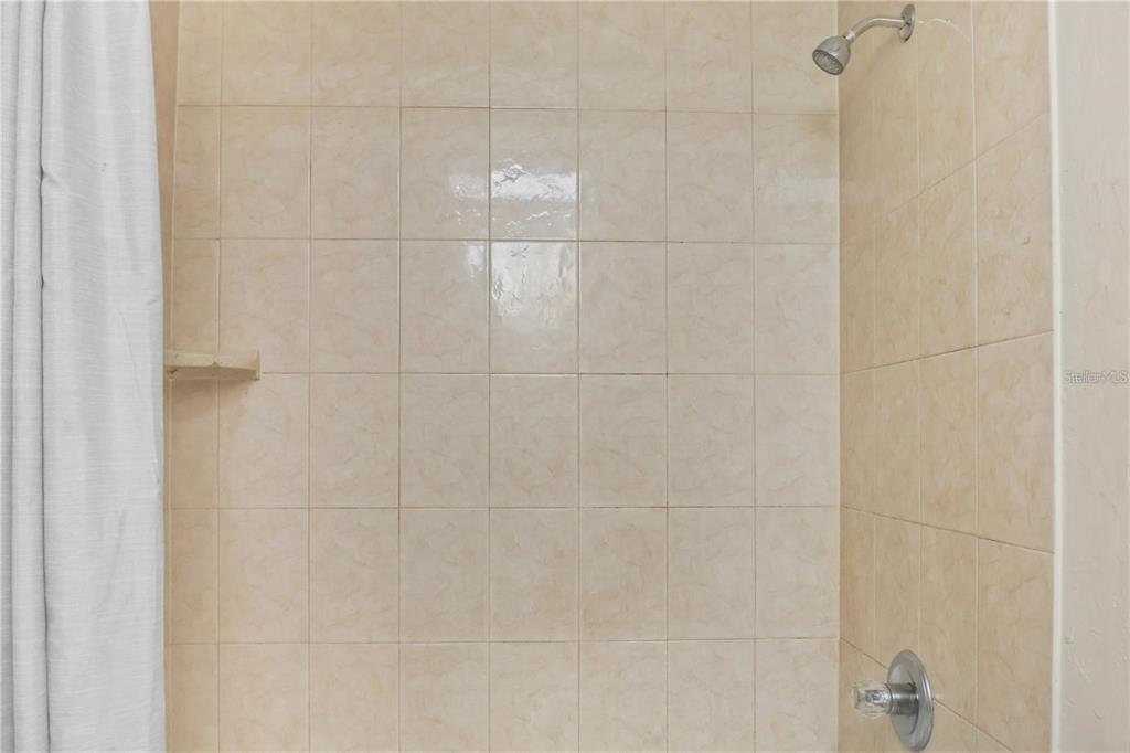 713 Southwest 69th Street Gainesville, FL 32607 - Photo 18 of 22 a bathroom with a shower