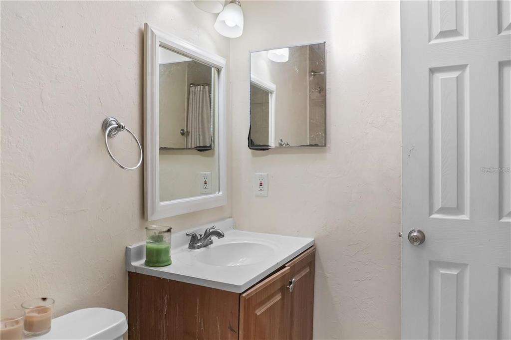 713 Southwest 69th Street Gainesville, FL 32607 - Photo 19 of 22 a bathroom with a sink vanity mirror and toilet