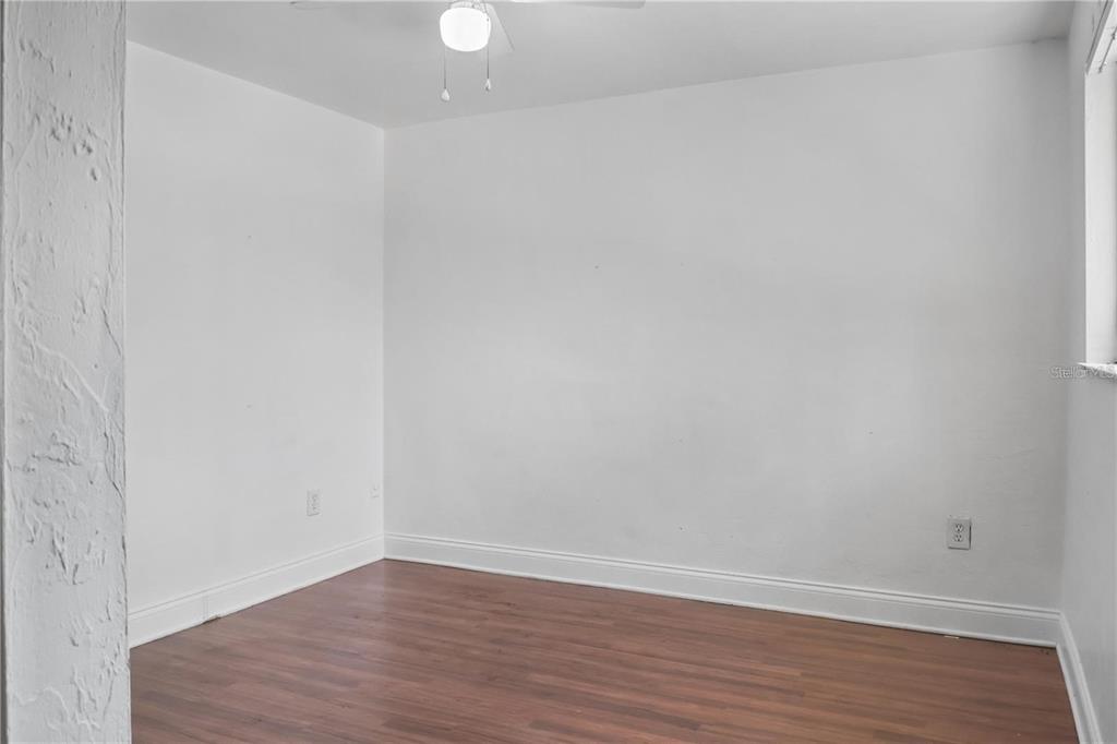 713 Southwest 69th Street Gainesville, FL 32607 - Photo 20 of 22 a view of an empty room with wooden floor