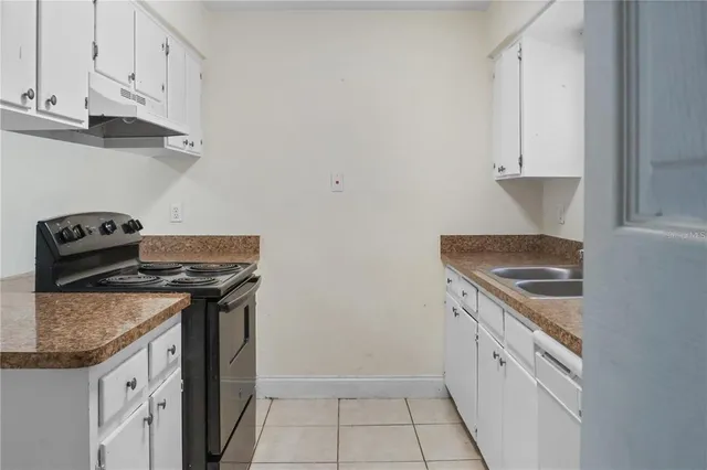 a kitchen with granite countertop a stove and a sink