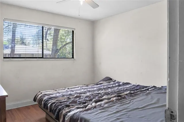 an empty room with windows and fan