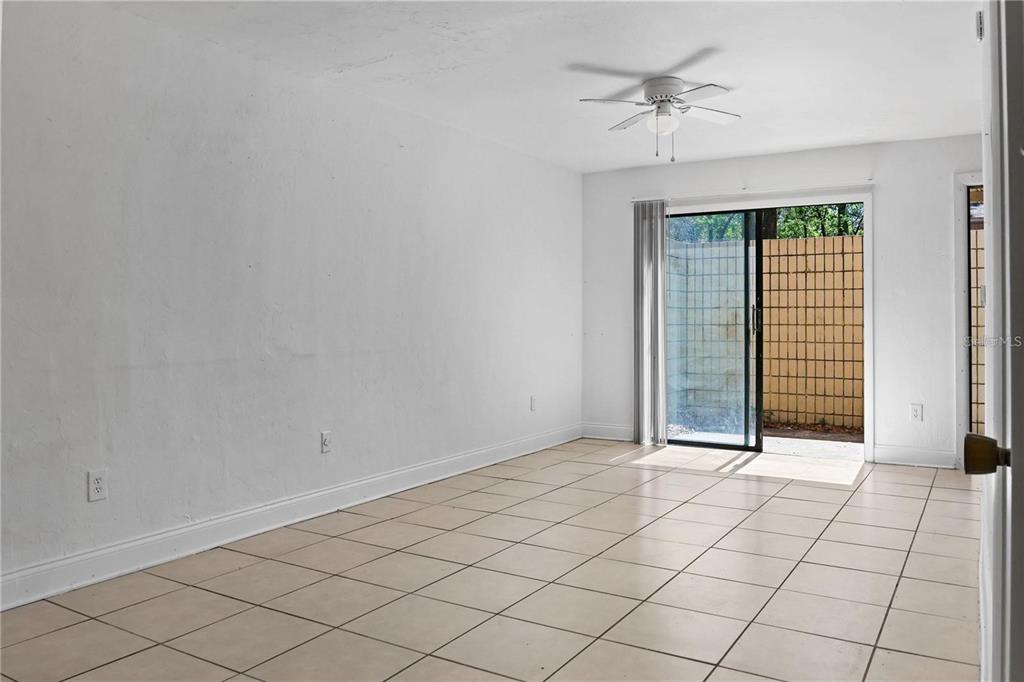 713 Southwest 69th Street Gainesville, FL 32607 - Photo 8 of 22 an empty room with windows and fan
