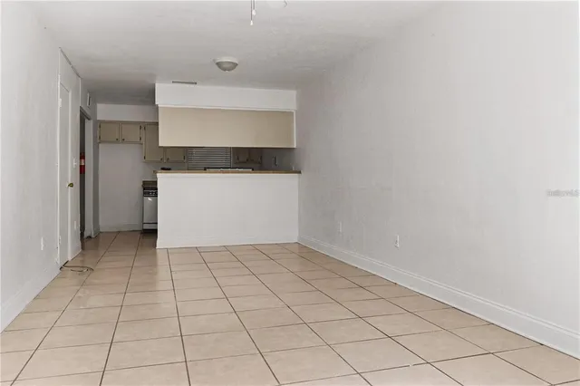 a kitchen with granite countertop stainless steel appliances a sink stove and cabinets