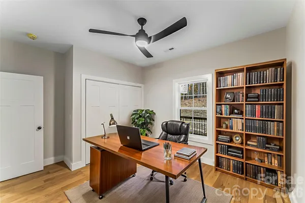 a living room with furniture and a book shelf