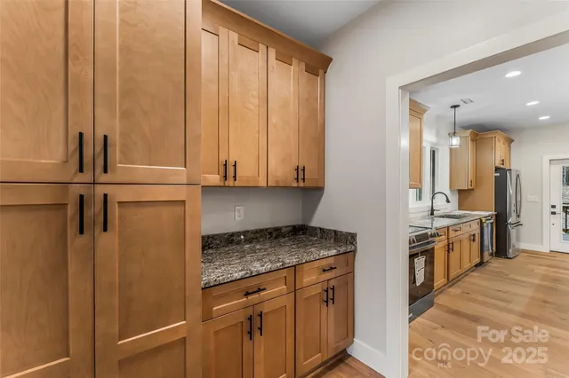 a kitchen with stainless steel appliances granite countertop cabinets and sink