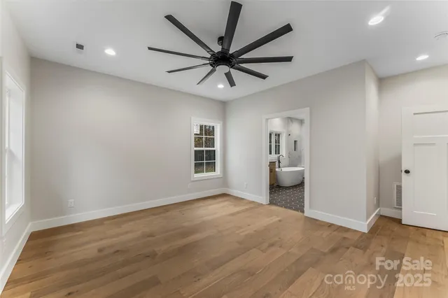 a view of a livingroom with a ceiling fan and wooden floor