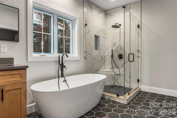 a bathroom with a bathtub and shower