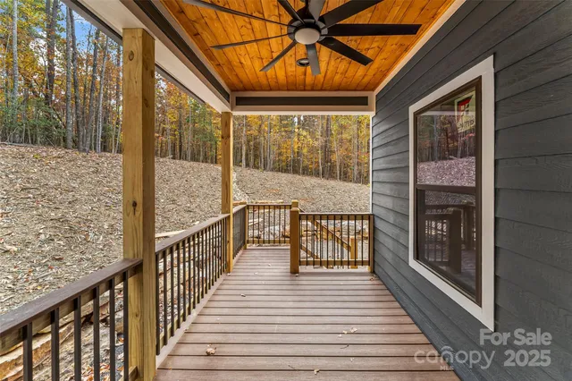 a view of a balcony with wooden floor and iron fence