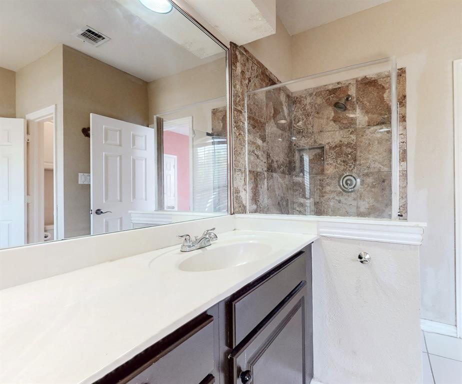 119 Parkhurst Lane Allen, TX 75013 - Photo 15 of 24 a bathroom with a sink mirror and a shower