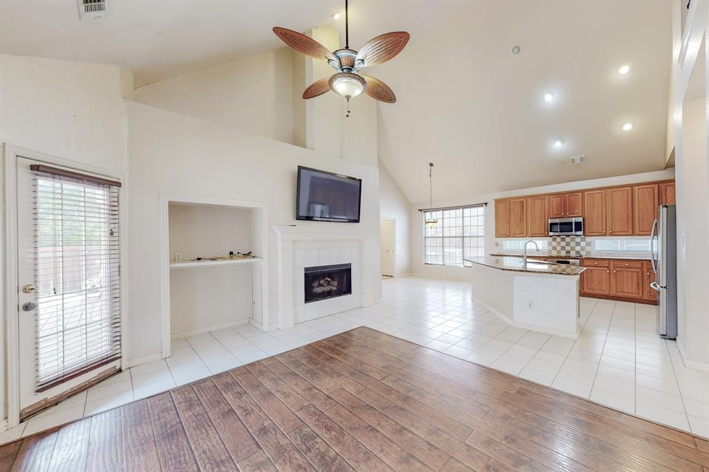 119 Parkhurst Lane Allen, TX 75013 - Photo 23 of 24 a large open kitchen with a refrigerator a stove top oven a chimney and a large window