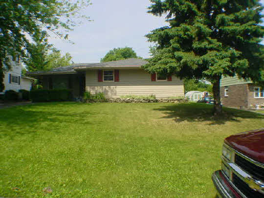 1013 Kenmore Road Rockford, IL 61108 - Photo 1 of 6 a front view of a house with garden