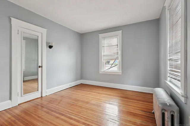 a view of a room with wooden floor and windows