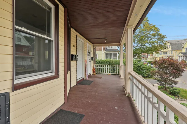 a view of a porch with wooden floor and stairs