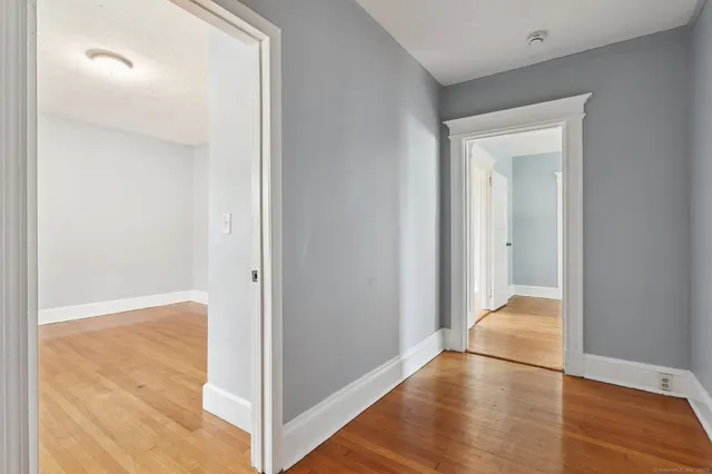 a view of hallway with wooden floor