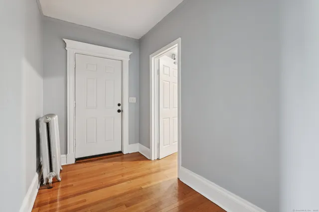 an empty room with wooden floor and closet