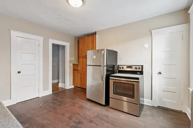 a kitchen with stainless steel appliances granite countertop a refrigerator and a stove top oven