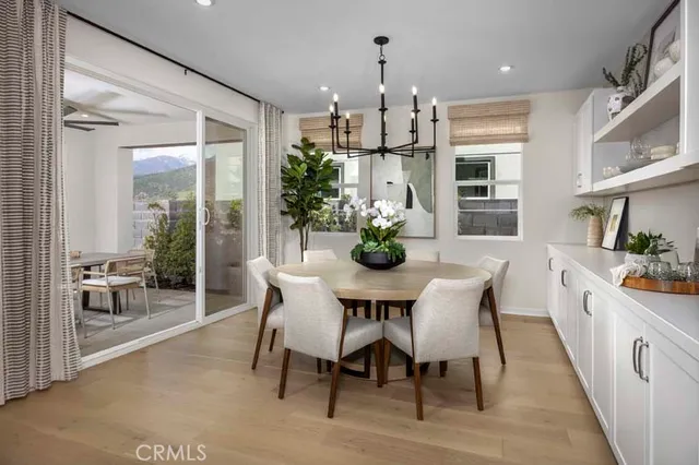 a view of a dining room with furniture and chandelier