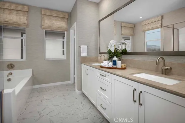 a bathroom with a sink a faucet a mirror and a bathtub