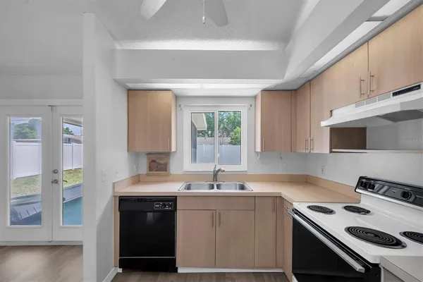 a kitchen with a sink stove and cabinets