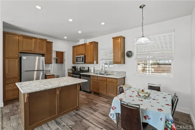 a open kitchen with stainless steel appliances granite countertop a sink stove and refrigerator