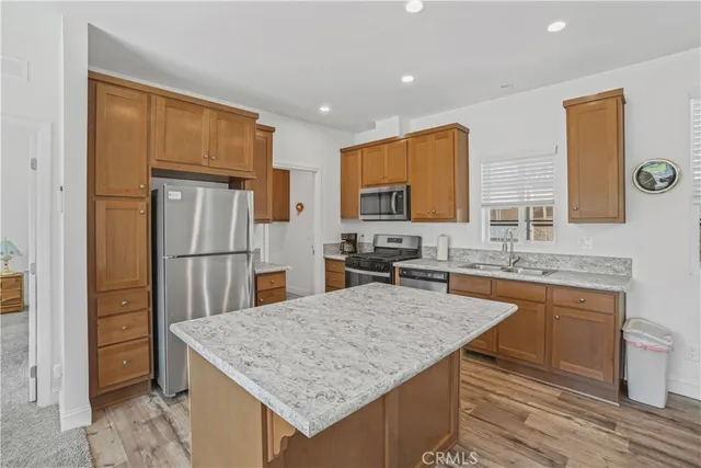 a living room with granite countertop furniture and a wooden floor