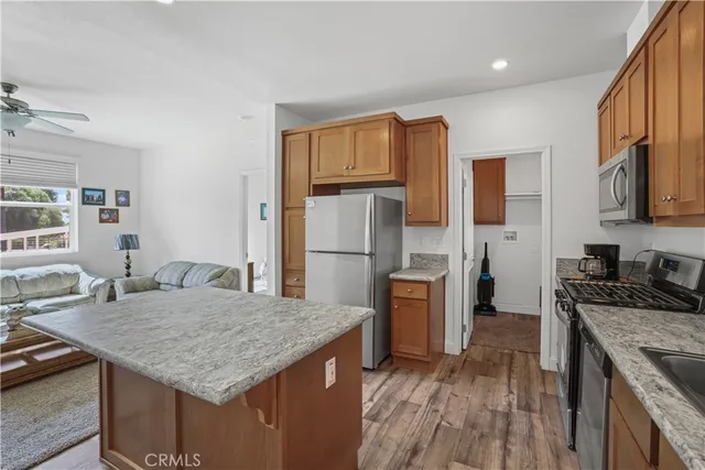 a kitchen with stainless steel appliances granite countertop a refrigerator and a stove