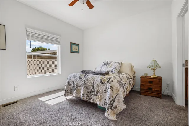 a bedroom with a bed and dresser
