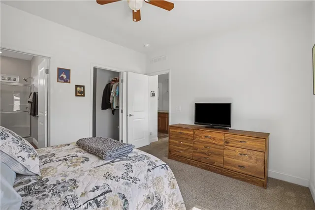 a bedroom with a bed and a television