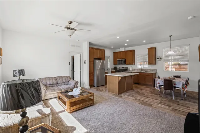 a living room with furniture a flat screen tv and a window