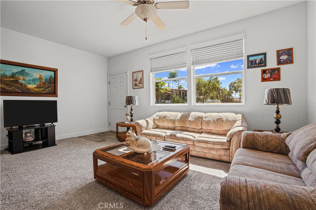 1700 South State Street, Unit 19 Hemet, CA 92543 - Photo 10 of 34 a living room with furniture a flat screen tv and a window